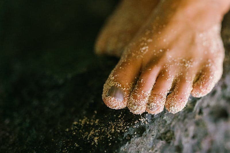 Close-up of a bare foot resting on stone, warm and calm