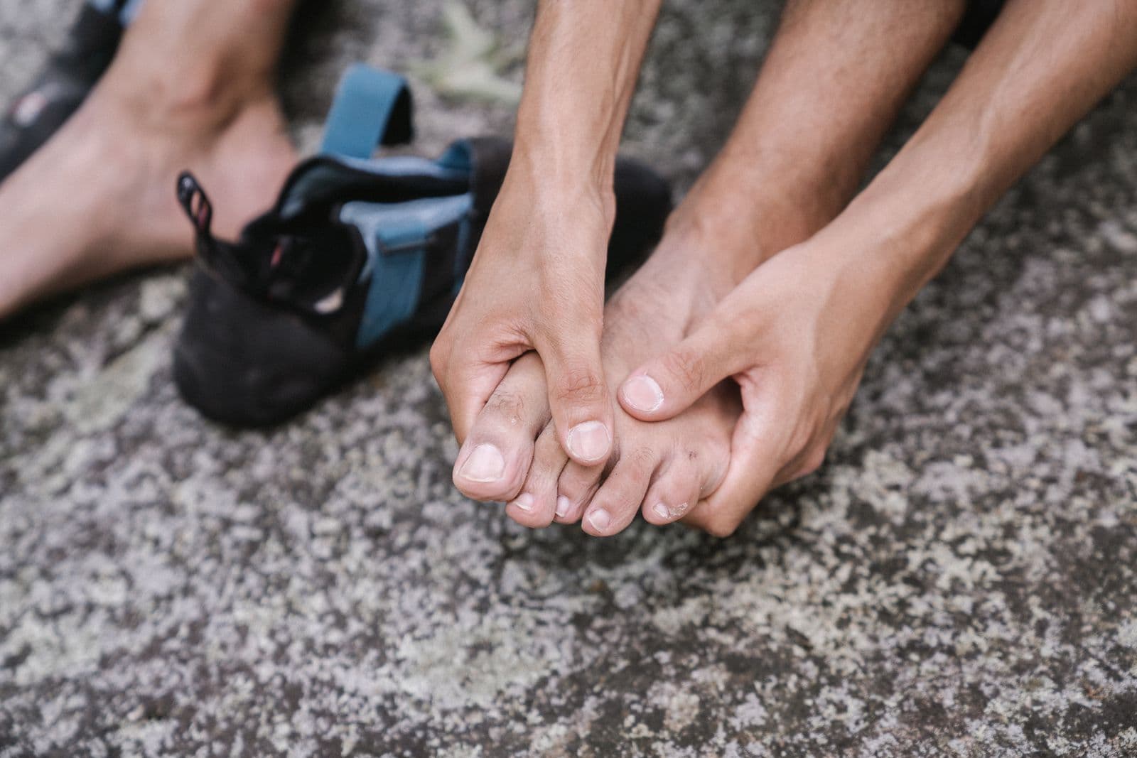 A man holding the toes of his bare foot